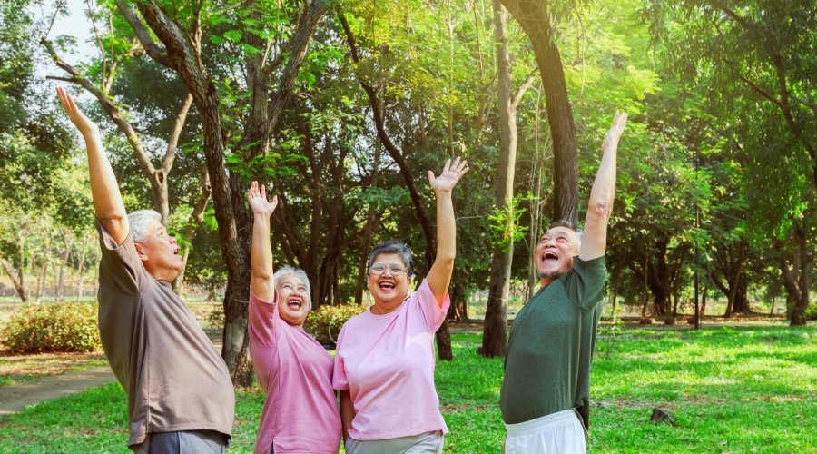 Group of older people cheering in a park