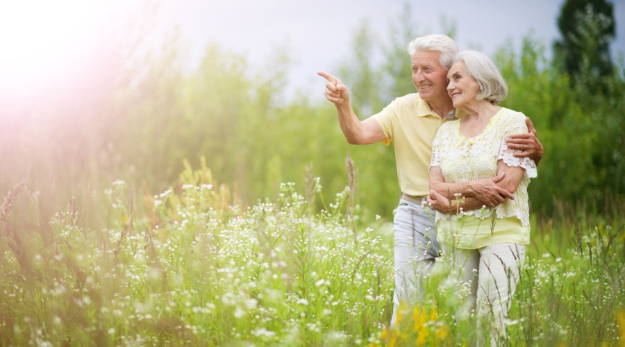 Older couple embracing in garden