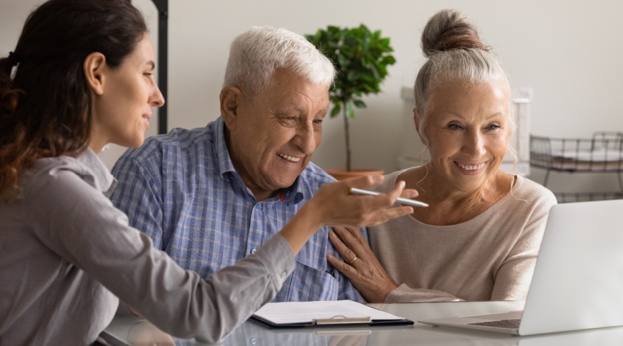 An older Canadian couple consulting with a financial advisor regarding LIRA and how to unlock your LIRA as a source of income