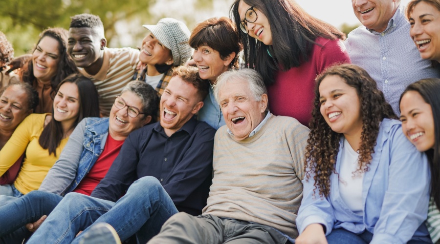 Older people laughing in a group with younger people