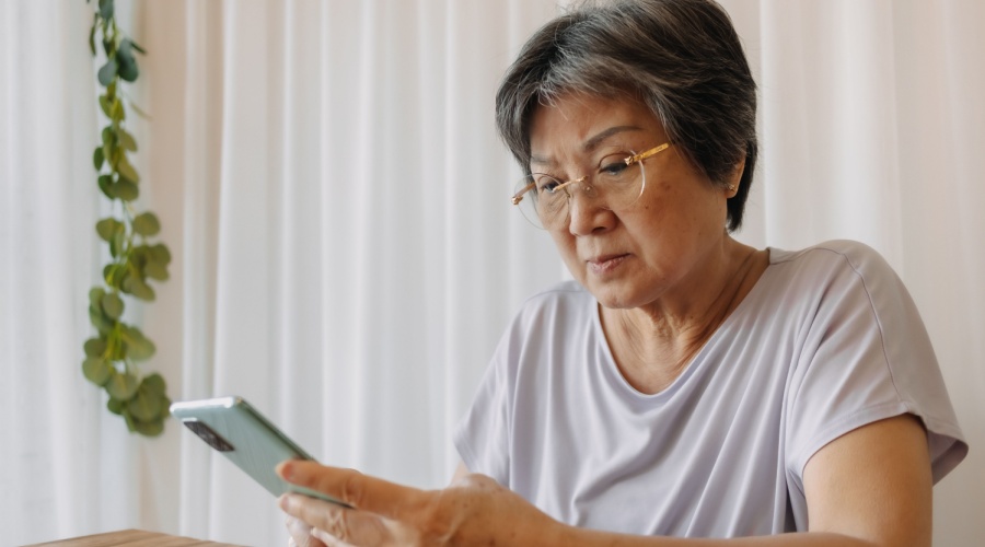 Older-woman-looks-concerningly-at-her-phone